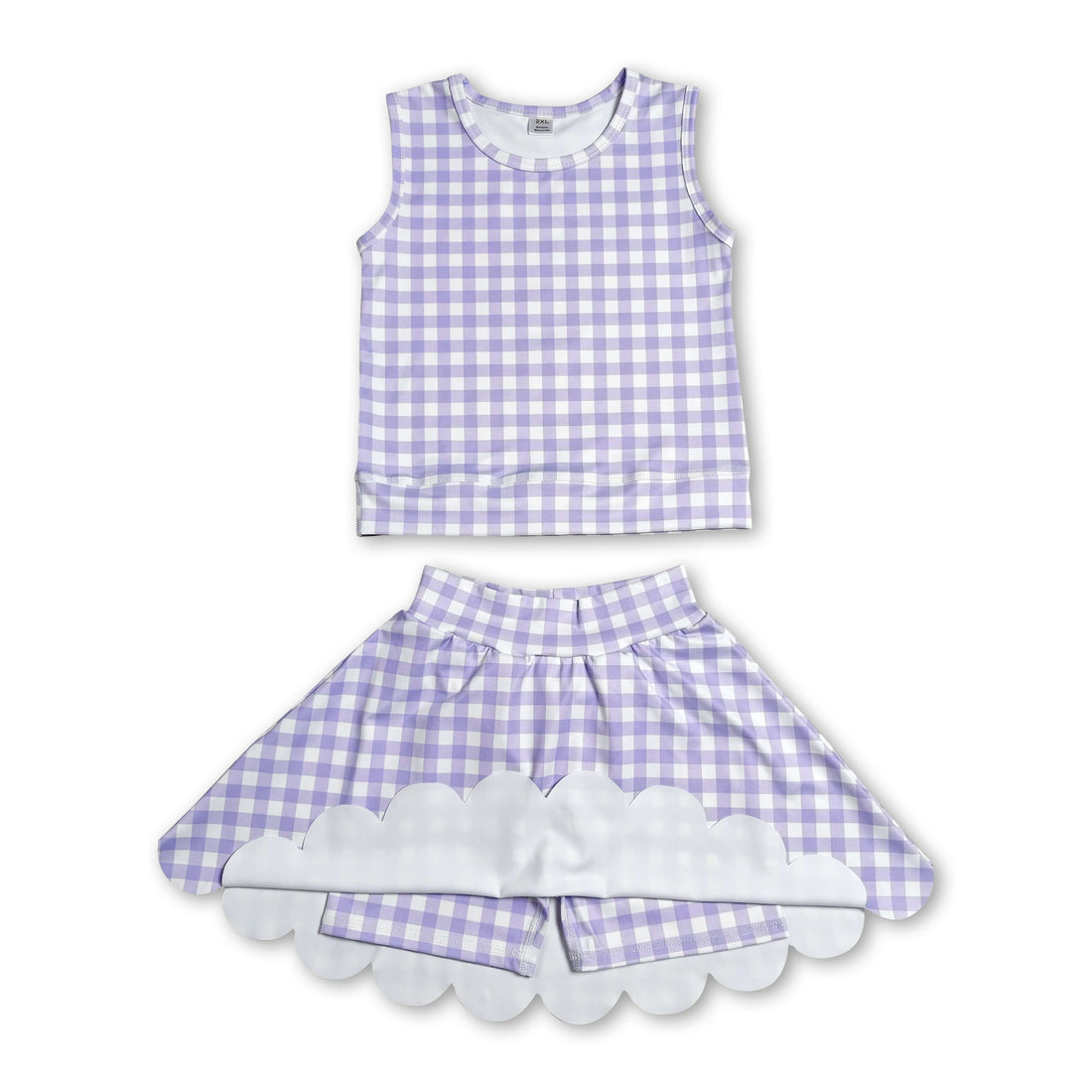 Girl wearing a lavender plaid sleeveless top and scallop skirt from Mini Rodeo&