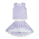 Girl wearing a lavender plaid sleeveless top and scallop skirt from Mini Rodeo&