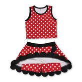 Red polka dots girl’s active wear set with scalloped short sleeve top and skirt by Mini Rodeo, perfect for active girls.