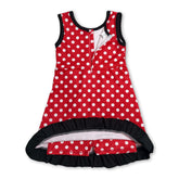 Little girl wears a sleeveless polka dot scallop hem Mini Rodeo athletic dress, featuring a short-sleeve design for kids.