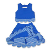 Girl wearing sleeveless blue plaid scallop skirt active wear set by Mini Rodeo, featuring a short-sleeve top and matching skirt.