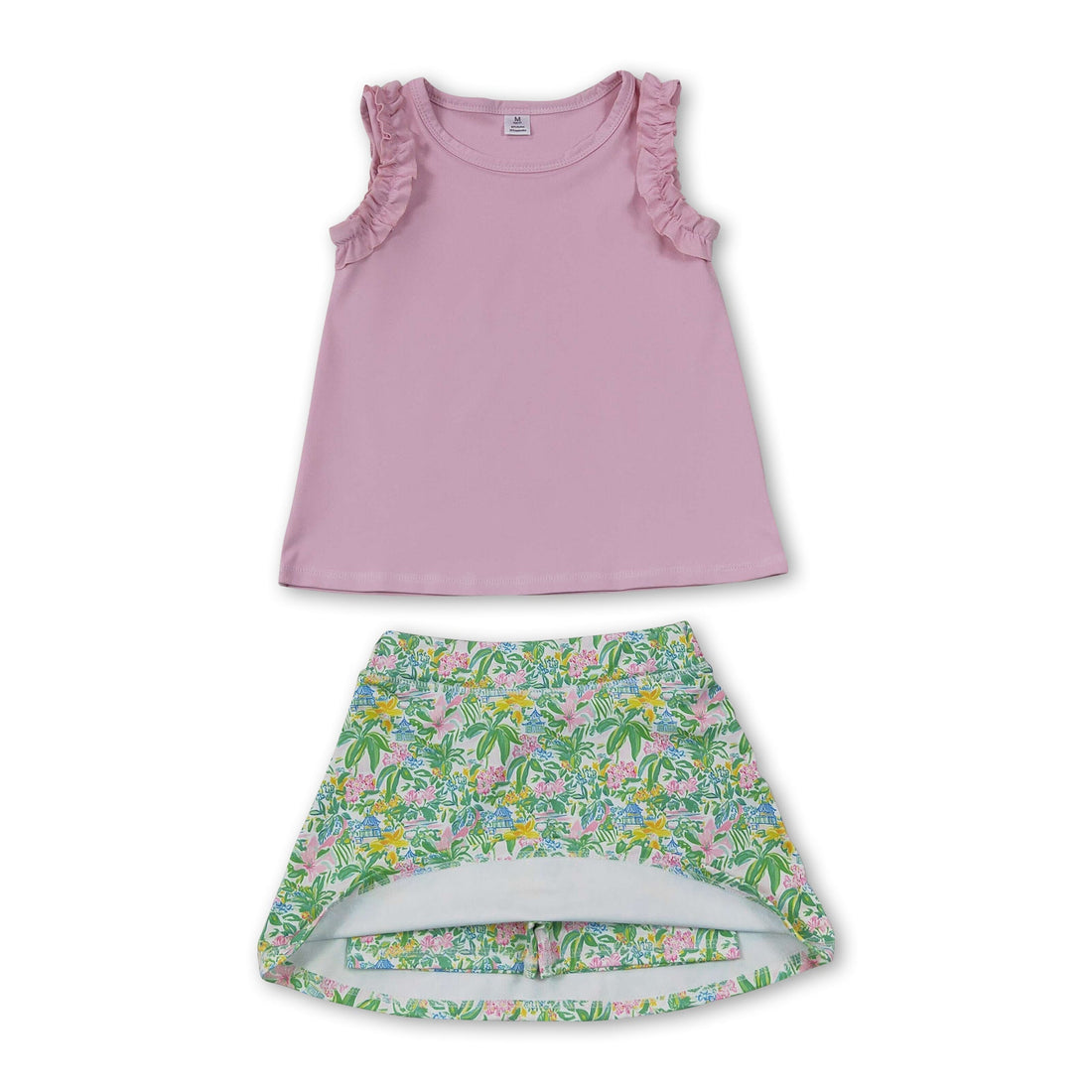 Girl wearing a sleeveless pink ruffle top and floral skirt from Mini Rodeo girl&