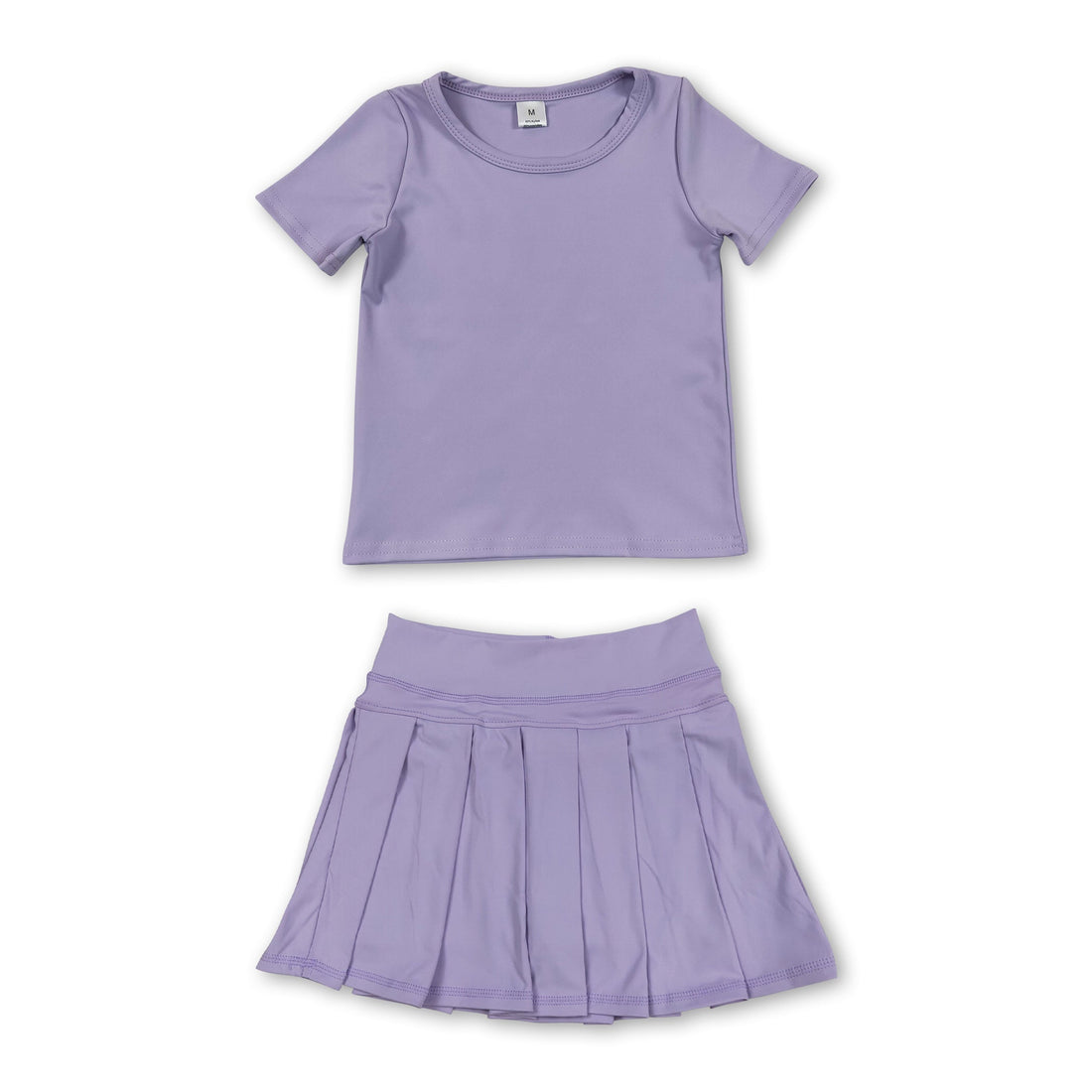 Girl wearing lavender short sleeve top and pleated skirt active wear set by Mini Rodeo, perfect for casual or active occasions.