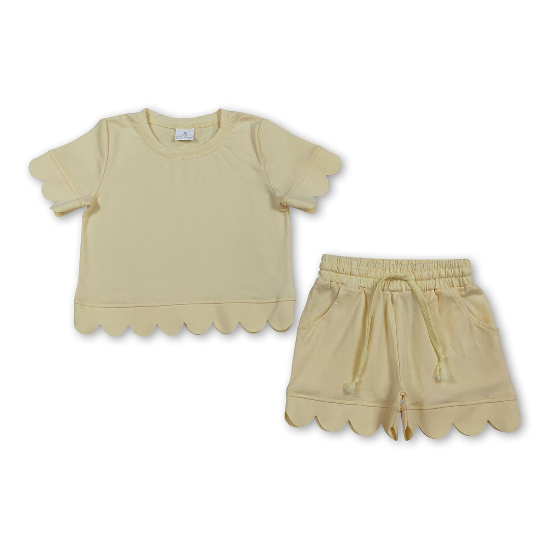 Girl wearing yellow scallop top and shorts set from Mini Rodeo, short-sleeve summer outfit for girls, casual and stylish.