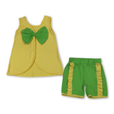 Girl wearing yellow, purple, and blue sleeveless bow shorts set by Mini Rodeo, perfect for summer outfits.