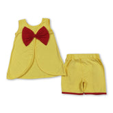 Girl wearing sleeveless red bow top and yellow shorts from Mini Rodeo princess girl outfit set, casual summer look.