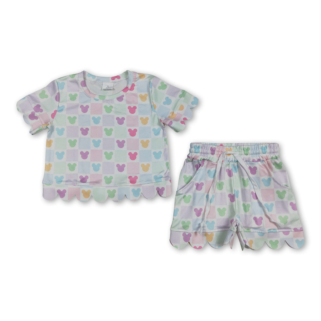 Colorful plaid girl’s short sleeves top and shorts set by Mini Rodeo featuring scallop details and playful design.