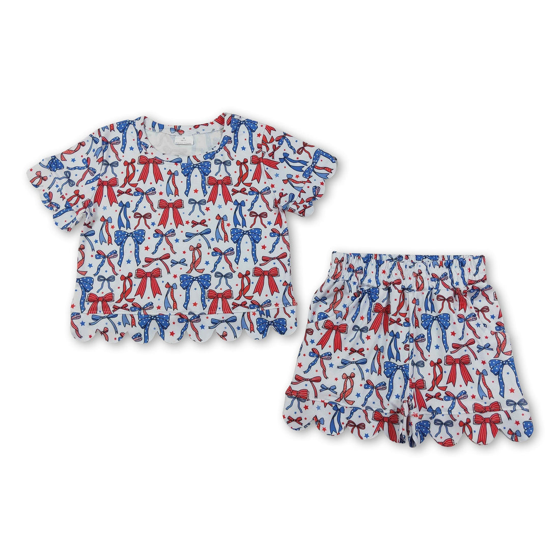 Red and blue girl’s short sleeves top and shorts set with bow and scallop details, perfect for 4th of July, by Mini Rodeo.