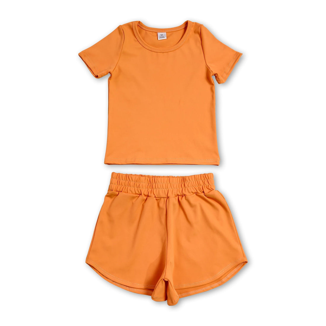 Kids girl short sleeves orange top and shorts yoga active set by Mini Rodeo, casual and comfortable for active play.