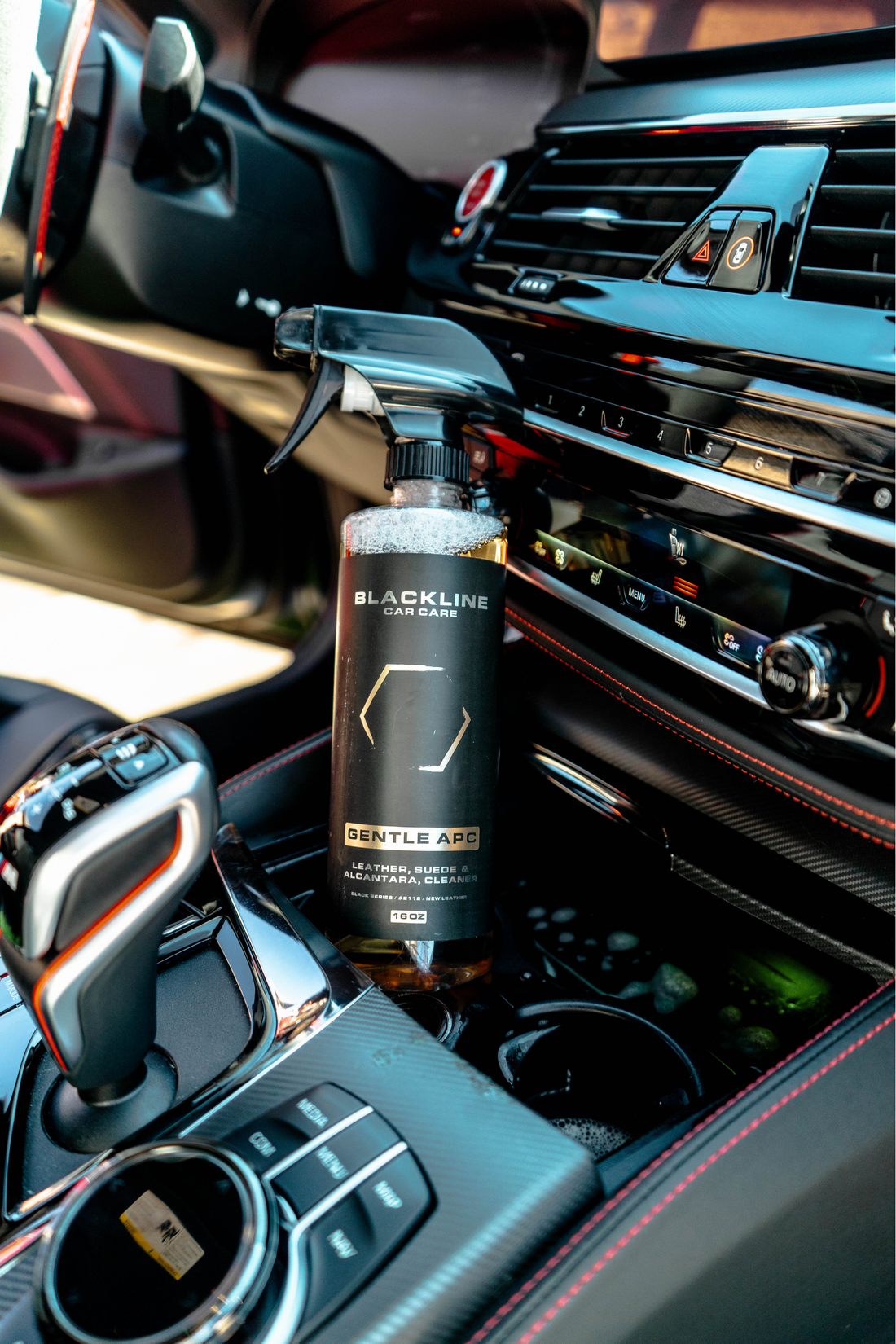 Blackline Car Care BLACKLINE® Gentle APC all purpose cleaner in a cup holder, showing its use for cleaning vehicle interior surfaces.