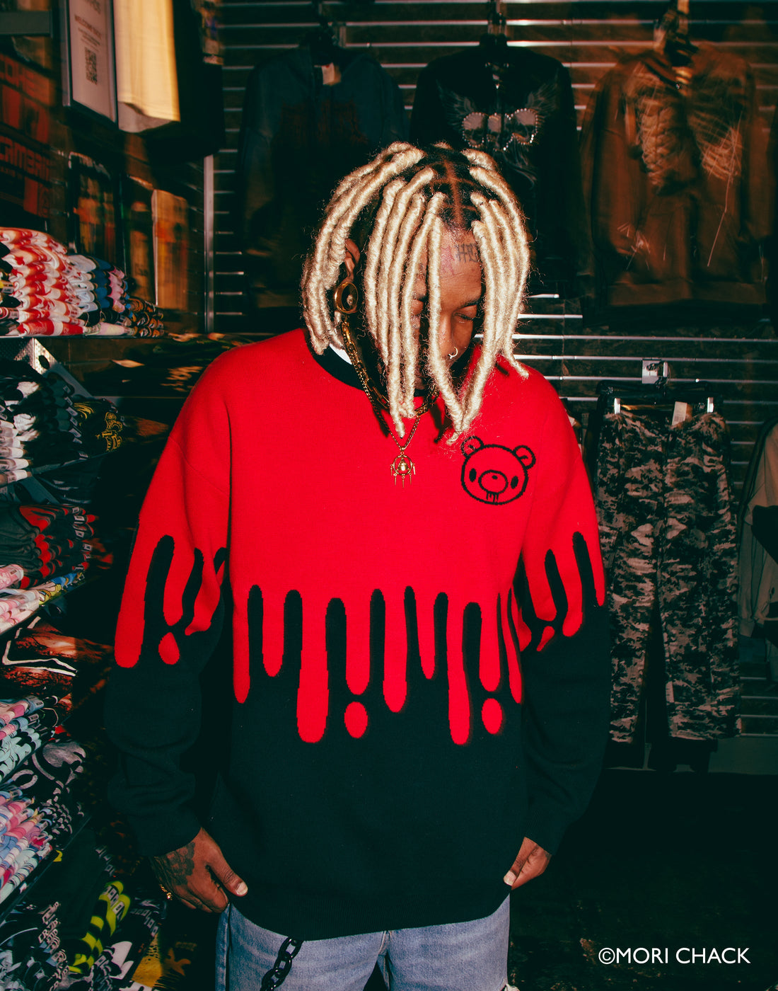 Gloomy Drip Knit Sweater by Any Means Necessary Clothing, featuring a dark, moody knit design with a relaxed fit.