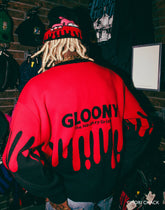 Gloomy Drip Knit Sweater by Any Means Necessary Clothing, featuring a dark drip pattern and cozy knit texture.