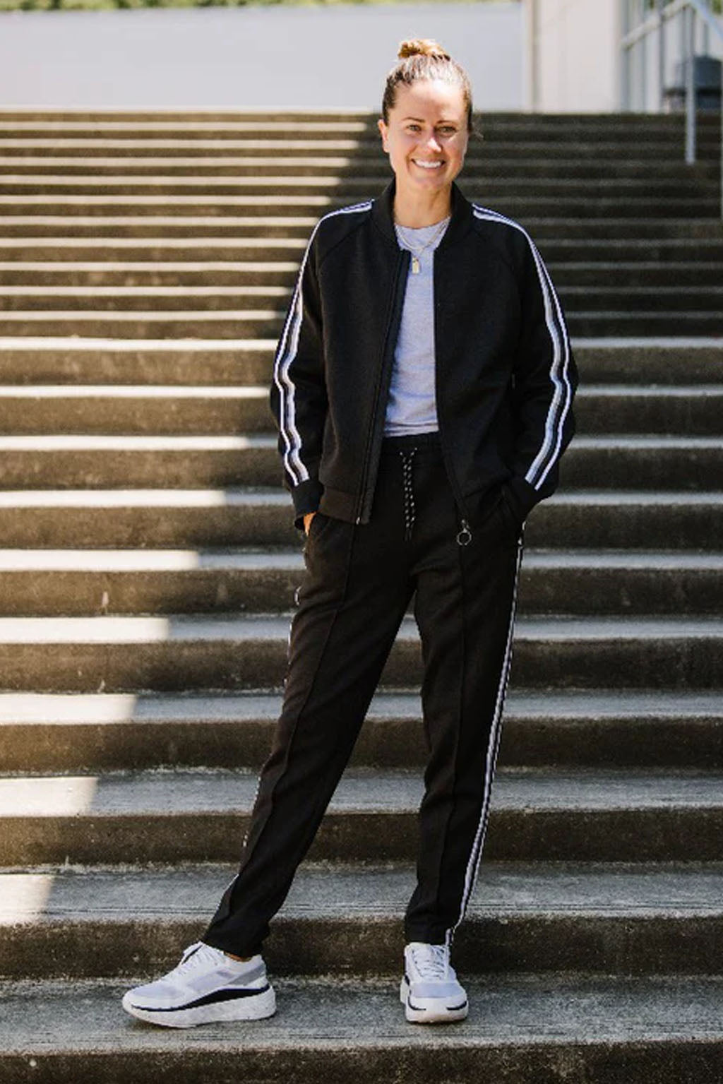 Black Goal Five Powerstripe mid-rise 28-inch 7/8 length track pants, stylish lifestyle athletic wear with a sleek design.