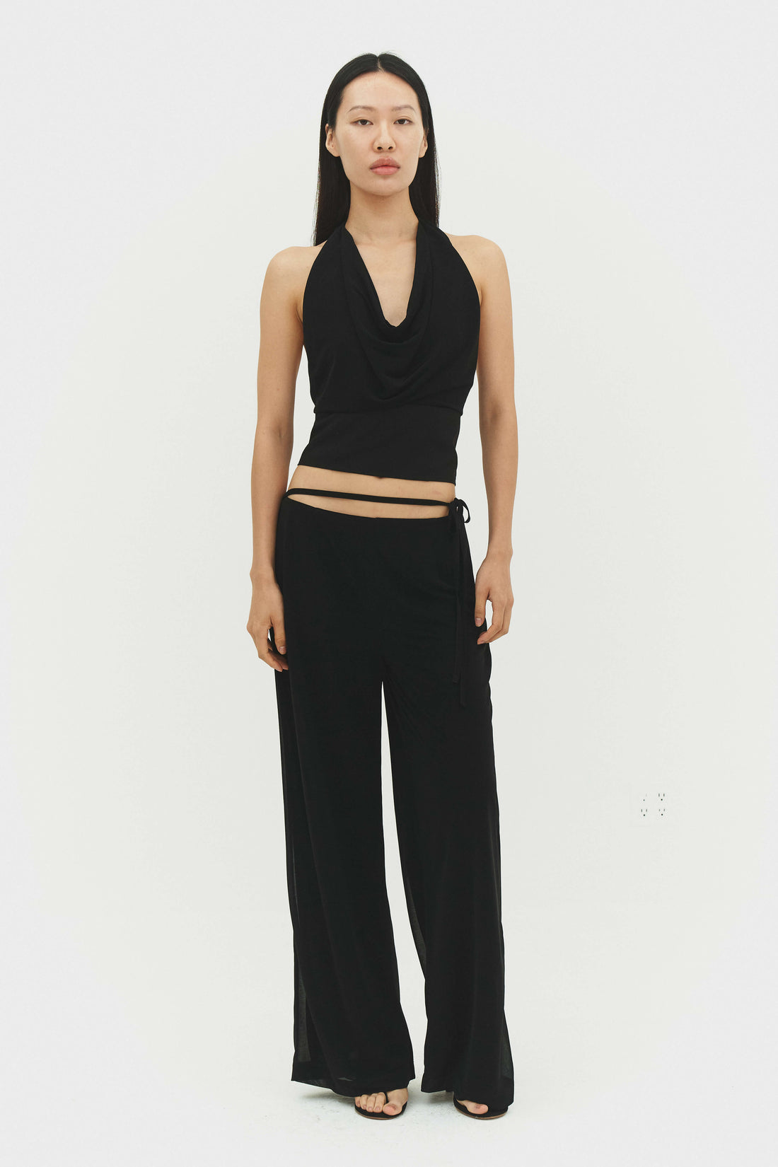 Black Emilia pants by findmenowthelabel, shown in a slim-fit style with smooth fabric and modern design.