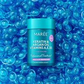 Maree keratin oil capsules for frizz control, showing glossy hair capsules in a clear container on a white background.