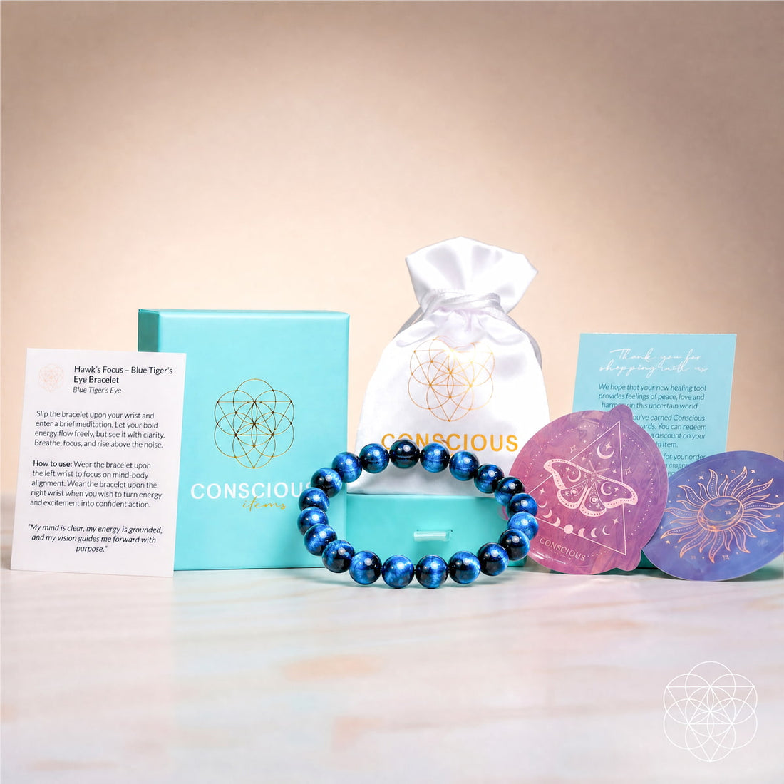 Royal blue Tiger’s Eye bracelet from Conscious Items with Hawk’s Focus packaging, featuring polished stones on an elastic band.
