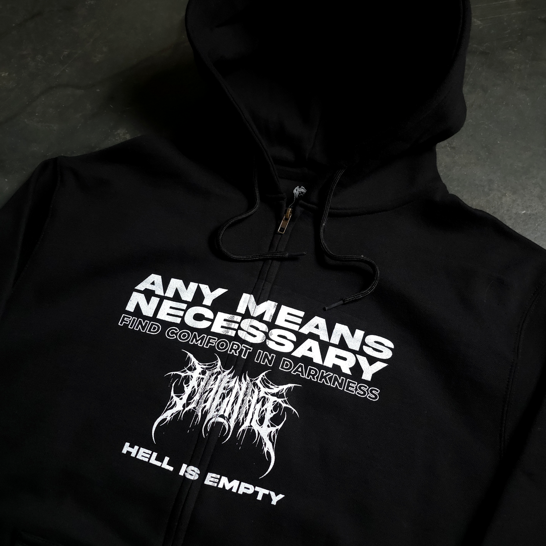 Black Hell is Empty zip-up hoodie by Any Means Necessary Clothing, front view showing hoodie with graphic design.