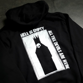 Black zip-up hoodie from Any Means Necessary Clothing with "Hell is Empty" graphic design on the front.