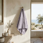 Soft white Capri Australian Cotton Bath Towels by Italic displayed folded on a clean bathroom surface.