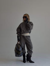 Charcoal sable pants by findmenowthelabel, featuring a stylish fit and smooth fabric, displayed on a hanger against a white background.