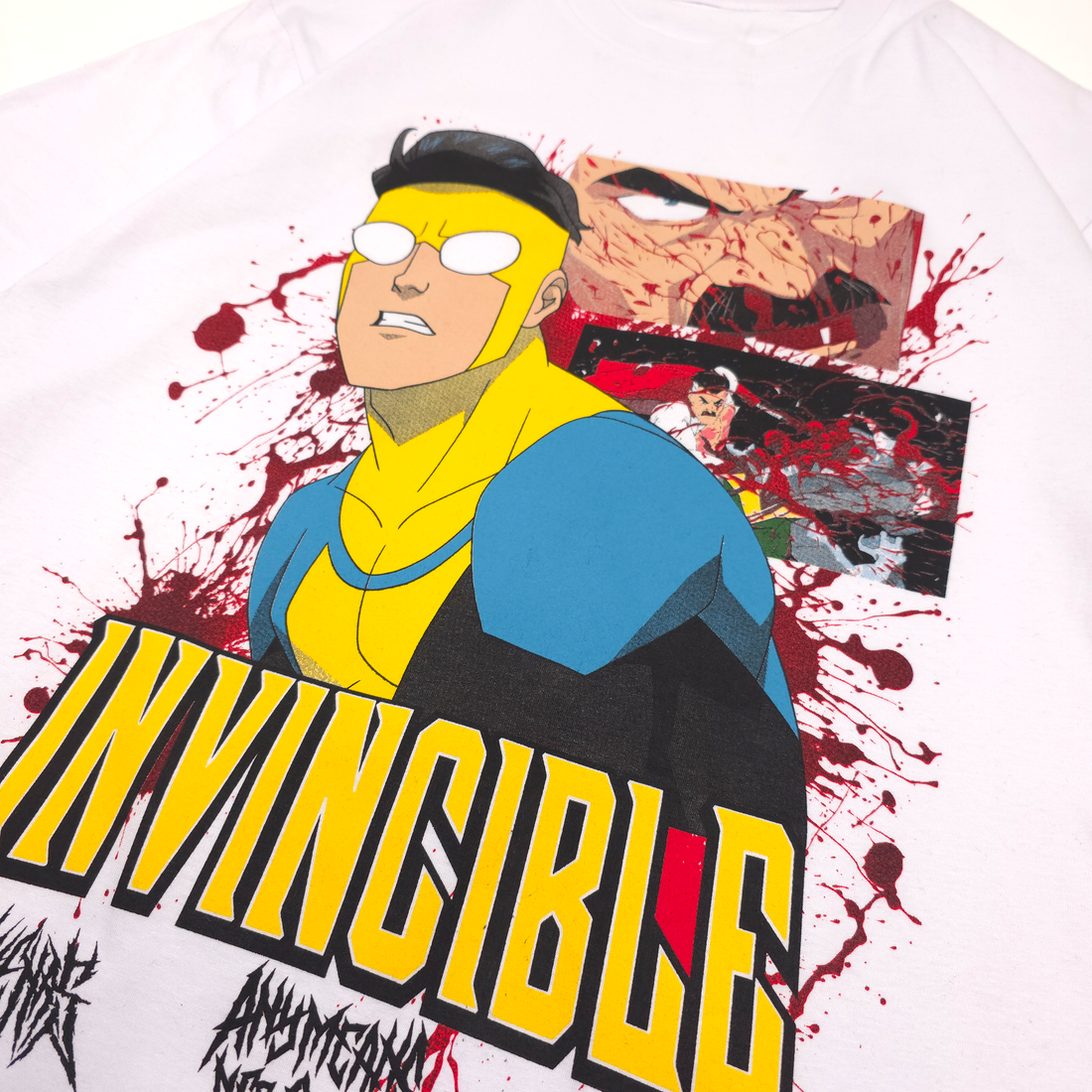 Close-up of white Betrayal T-Shirt by Any Means Necessary Clothing, featuring bold graphic design on front.