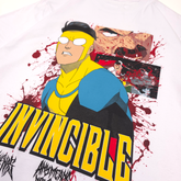 Close-up of white Betrayal T-Shirt by Any Means Necessary Clothing, featuring bold graphic design on front.