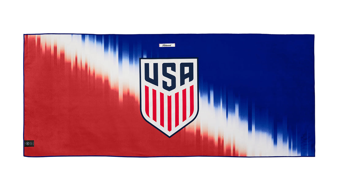 U.S. Soccer 2024 Knockaround Adventure towel by Goal Five, shown in a lifestyle setting with vibrant, sporty design and soft fabric texture.