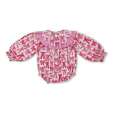 Pink bow smocked baby girl romper by Mini Rodeo featuring a Valentine’s Day theme, with a cute bow detail and soft bubble fabric.