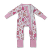 Pink heart-themed girl sleeper romper with zipper closure, featuring western-style boots and hat, by Mini Rodeo.