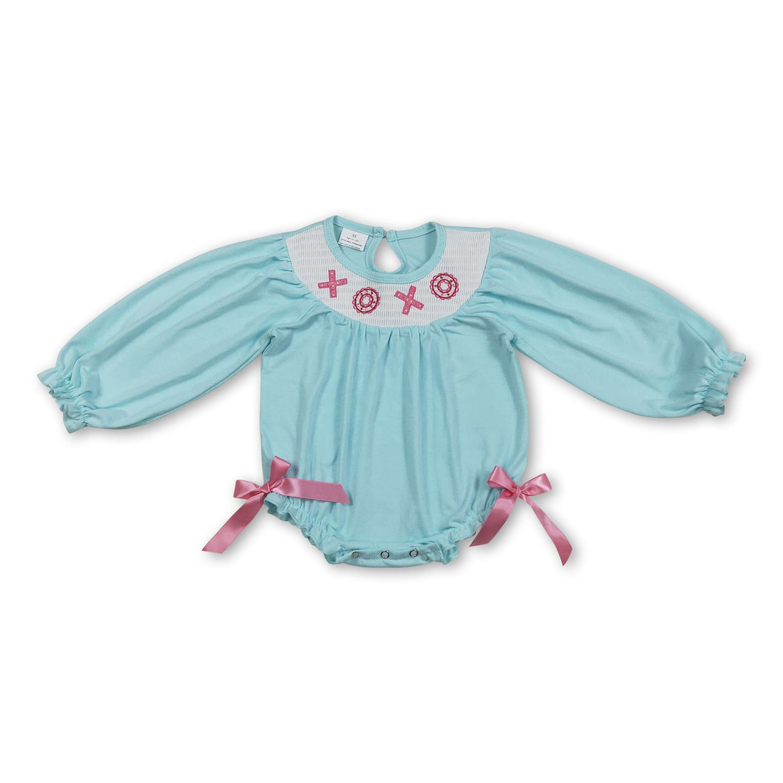 Baby girl Valentine’s romper with long sleeves, smocked details, featuring donuts and XOXO print from Mini Rodeo&
