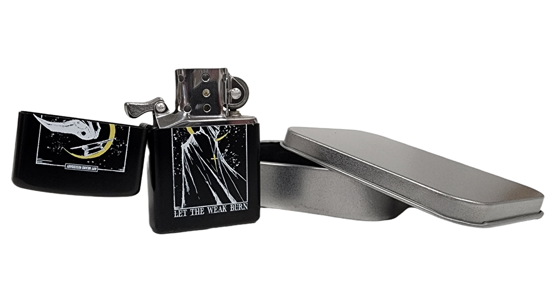 Let The Weak Burn lighter by Any Means Necessary Clothing, compact metal lighter with engraved design and flame ignition.