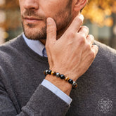Lifestyle image of the Conscious Items Triple Protection Bracelet with braided design and adjustable clasp, worn on a person&