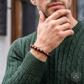 Mahogany Obsidian bracelet from Conscious Items featuring natural stone beads on a leather cord, styled in a lifestyle setting.