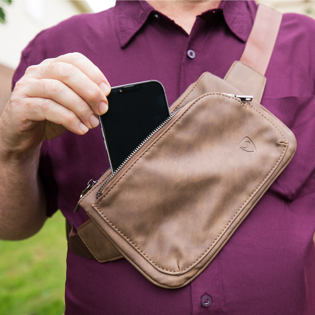 Shield Your Body Metro vegan leather cross body fanny pack with mobile phone pocket, worn as a stylish accessory in a lifestyle setting.