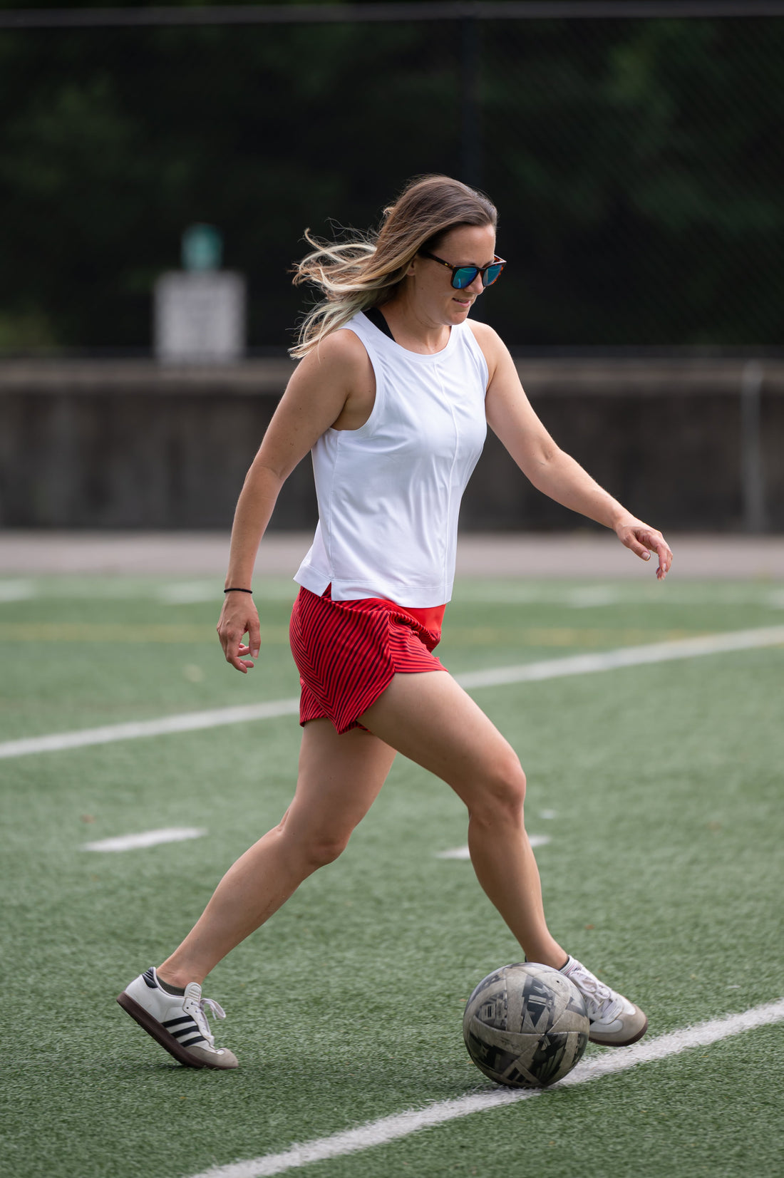 Goal Five boxy crop tank top worn in a lifestyle setting, showcasing its relaxed fit and casual style.