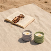 Italic soy wax ceramic candle with lilac and matcha scent in a stylish ceramic container, set against a Provence-inspired background.