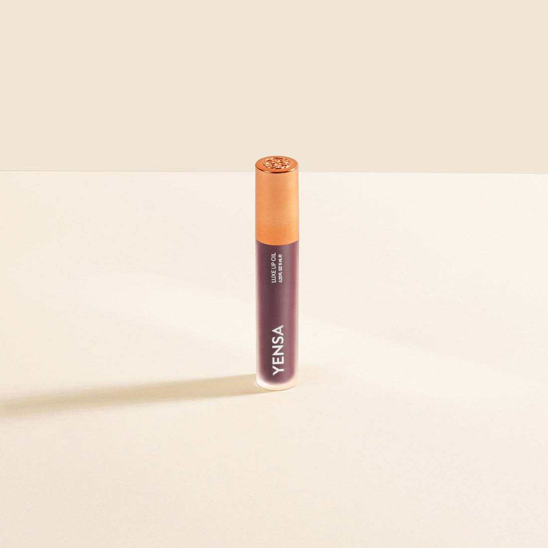 YENSA Luxe Lip Nourishing Oil with hyaluronic acid and vitamin E, featuring a glossy berry-colored lip oil in a sleek bottle