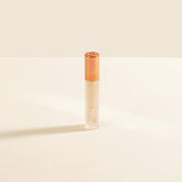 YENSA Luxe Lip Nourishing Oil with hyaluronic and vitamin E, clear lip oil bottle showing glossy finish and applicator tip.