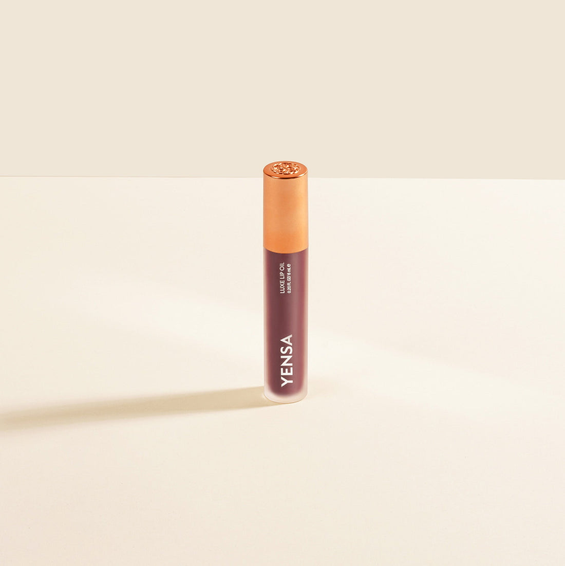 YENSA Luxe Lip Nourishing Oil with hyaluronic and vitamin E applied on mauve lips, showcasing glossy, smooth lip finish.