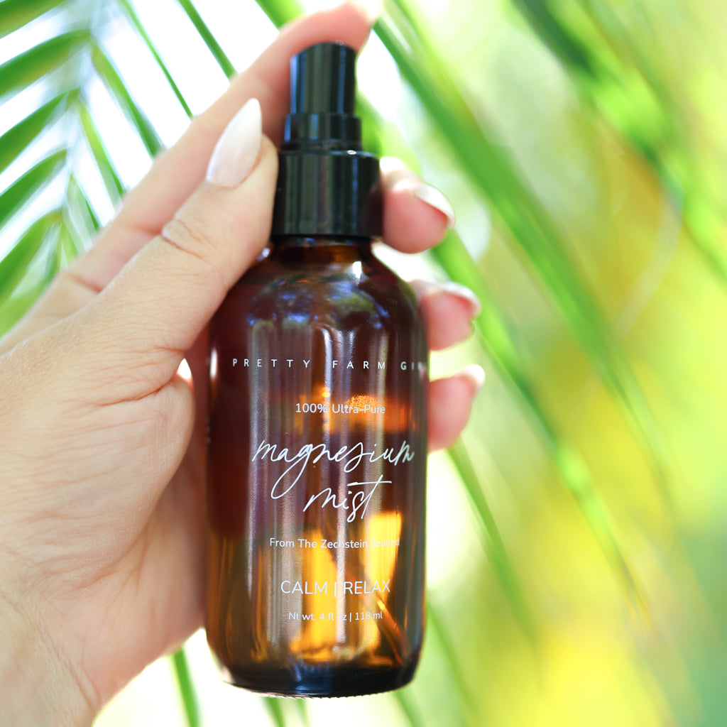 Pretty Farm Girl magnesium mist body spray toner bottle with a spray nozzle, shown on a neutral background.