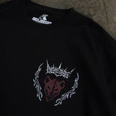 Close-up of black Mantra T-Shirt by Any Means Necessary Clothing, showing the fabric and neckline detail.