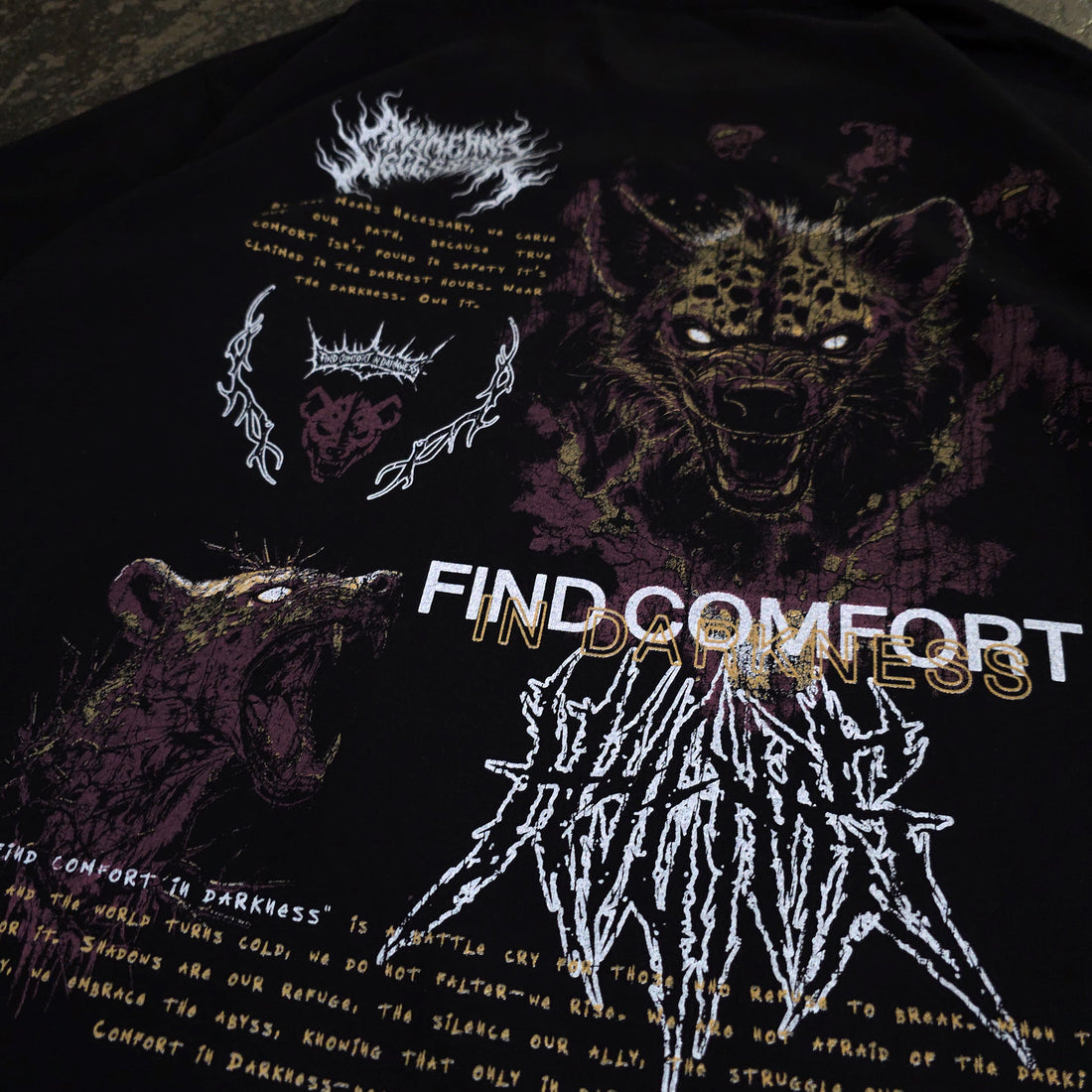 Close-up of black Mantra T-Shirt by Any Means Necessary Clothing, featuring the printed mantra design on the front.