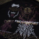 Close-up of black Mantra T-Shirt by Any Means Necessary Clothing, featuring the printed mantra design on the front.