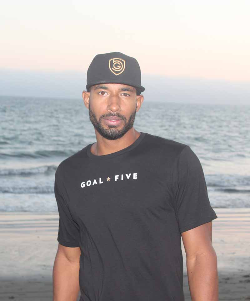 Men wearing Goal Five black cotton T-shirt, casual lifestyle shot showcasing the comfortable fit and soft fabric.