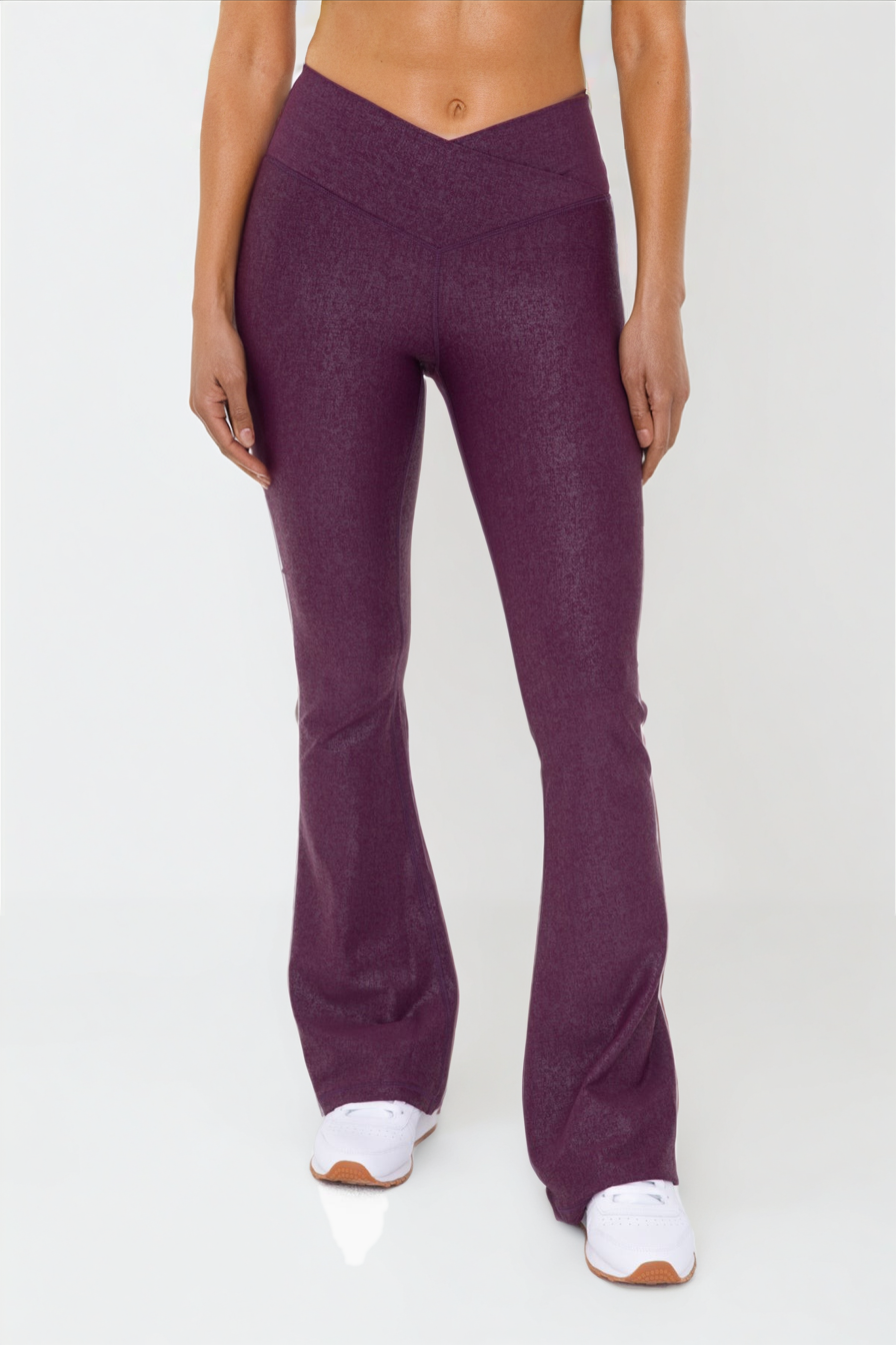 Black Luxe Edge leather-look crossover flare leggings by Fitkitty Culture, showcasing the stylish high-waist design and flared hem.