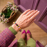 Rainbow tourmaline bracelet called The Spiral Breaker by Conscious Items featuring colorful gemstone beads on a stretch bracelet.