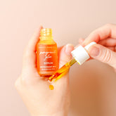 Pretty Farm Girl Pomegranate Glow Face Serum in a 0.5oz bottle, showcasing natural skin protection ingredients with a vibrant label.
