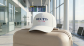 White Fitkitty Culture logo baseball cap, casual hat with adjustable strap, featuring embroidered Fitkitty branding.