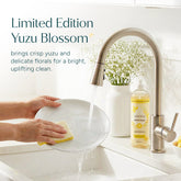 Puracy Yuzu dish soap in a clear bottle with a yellow label, showing a splash of water and fresh citrus fruits.