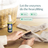 Puracy laundry stain remover bottle with a white label and orange cap, designed to treat tough stains on clothing.